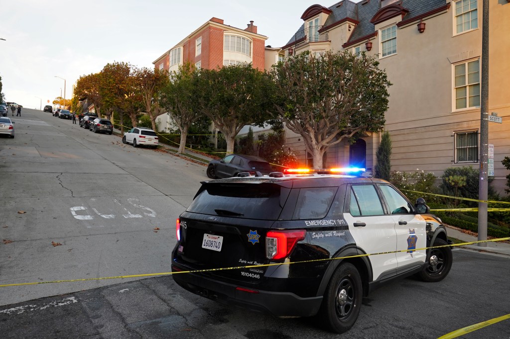 A police car blocks the street below the home of House Speaker Nancy Pelosi and her husband Paul Pelosi in San Francisco, on Oct. 28, 2022. 